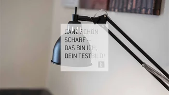 Black adjustable desk lamp against a blurred background