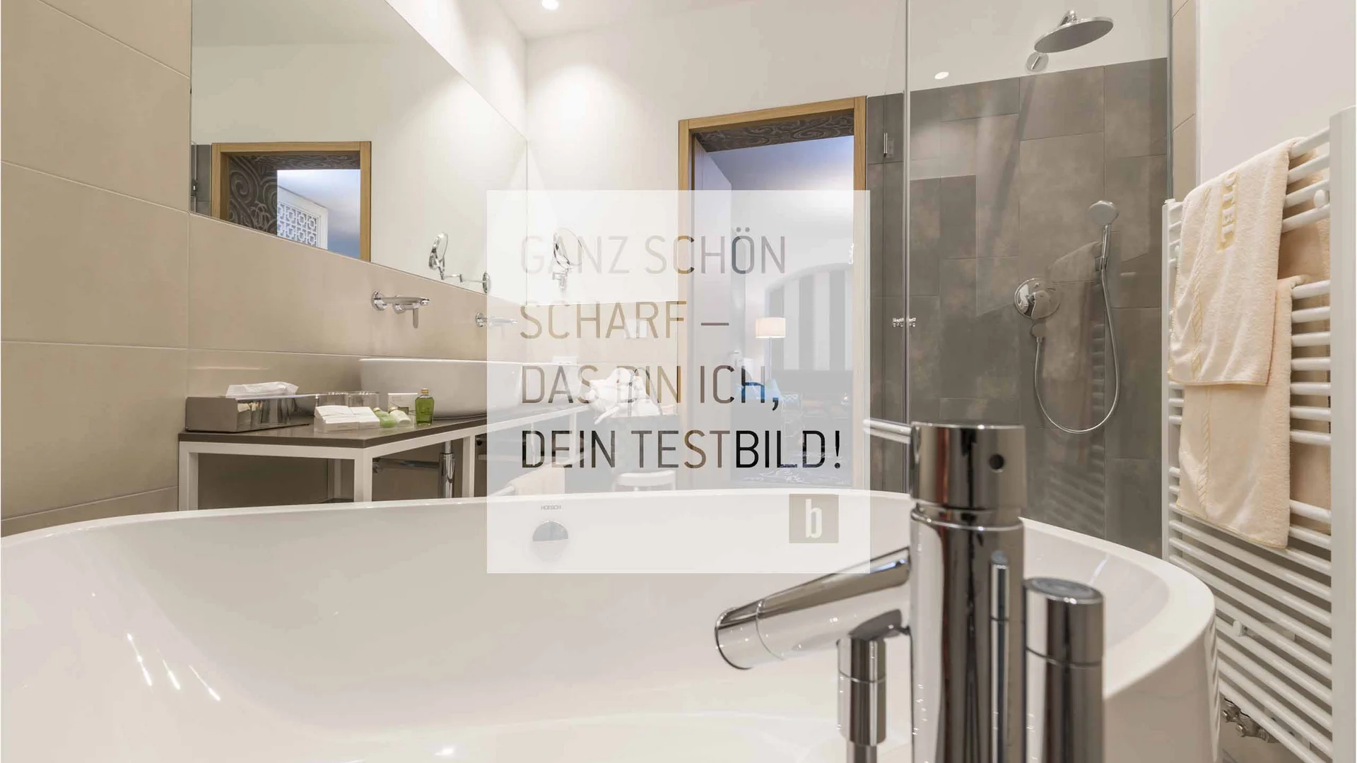 Moderner Badezimmerbereich mit Badewanne, Dusche und Handtüchern